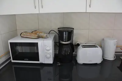 a microwave and a toaster on a kitchen counter at Blife Chelsya private apartment in Faro