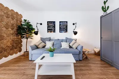 a living room with a blue couch and a table at Luxury Apartment Salgados Village in Guia