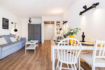 a living room with a blue couch and a table at Luxury Apartment Salgados Village in Guia