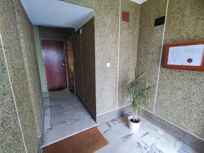 a hallway with a door and a potted plant at Algarve, cozy T1plus1 apartment in the centre of Quarteira in Quarteira