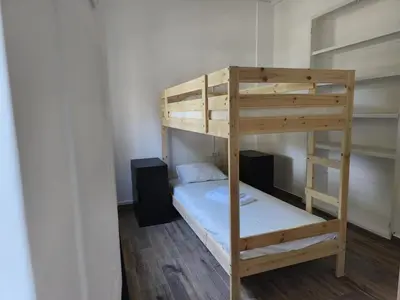 a bunk bed in a room with a ladder at Chill Spot - Faro Hostel in Faro