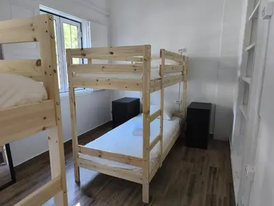a bedroom with a bed with two towels on it at Chill Spot - Faro Hostel in Faro