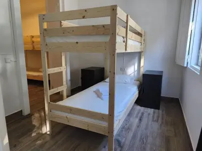a bedroom with a bed and a window at Chill Spot - Faro Hostel in Faro