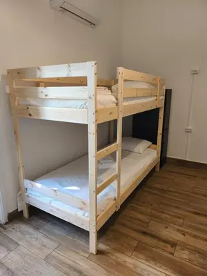 a room with two beds and a window and two mirrors at Chill Spot - Faro Hostel in Faro