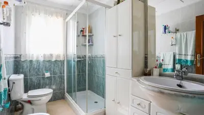 a bathroom with a toilet and a shower and a sink at Casa Donis 2021 in Albufeira
