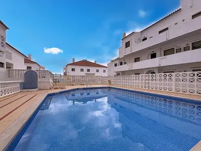 a swimming pool in front of a building at Albufeira prime stay 2 in Albufeira