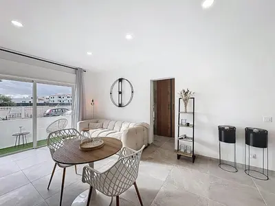 a living room with a couch and a table and chairs at Albufeira prime stay 2 in Albufeira