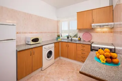a kitchen with a plate of fruit on a counter at Apartamentos Casa Brito, Boliqueime by AlgarveBlossom in Boliqueime