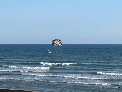 a kite is flying over the ocean at Casa Oura Praia located 100 metres from the beach in Albufeira