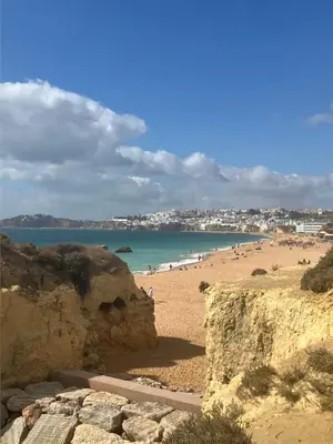 a view of a beach with people in the water at Casa Oura Praia located 100 metres from the beach in Albufeira