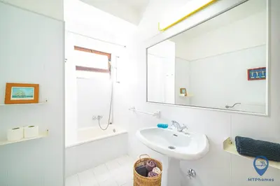 a white bathroom with a sink and a mirror at Balaia Mar 63D By MTPhomes in Albufeira