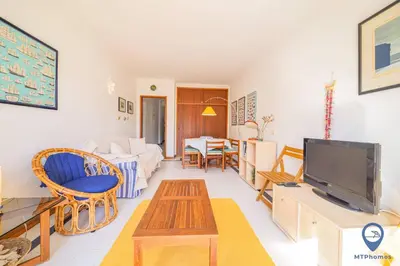 a living room with a couch and a tv at Balaia Mar 63D By MTPhomes in Albufeira