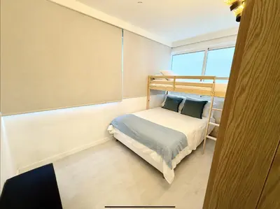 a small bedroom with a bunk bed and a window at Sunrise Apartment in Albufeira