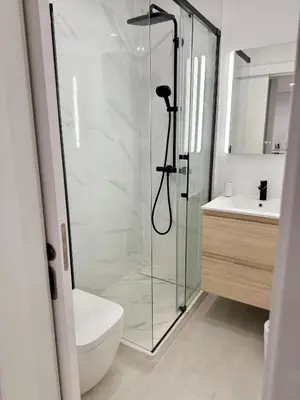 a bathroom with a shower and a toilet and a sink at Sunrise Apartment in Albufeira