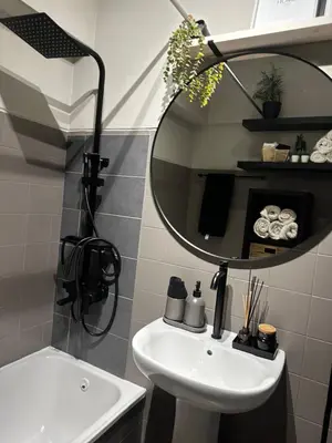 a bathroom with a white sink and a mirror at Beach Holiday House T1 in Quarteira
