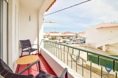 a balcony with chairs and a view of a street at Eva Andorinha 5 Pax by MTPhomes in Albufeira