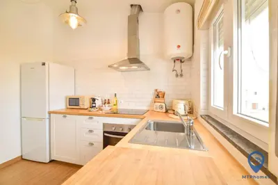 a kitchen with a sink and a white refrigerator at Eva Andorinha 2 Pax by MTPhomes in Ferreiras