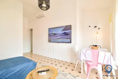 a bedroom with a table and a bed and a tv at Eva Andorinha 2 Pax by MTPhomes in Ferreiras