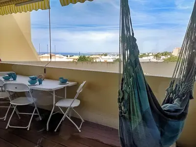 a table and chairs in a room with a window at Apart Palmeira Galé - Sea view - WIFI - BY BEDZY in Guia