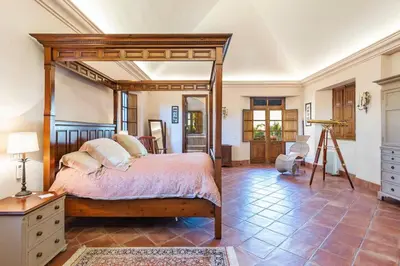 a bedroom with a large canopy bed in a room at Vistas Algarve in Loulé