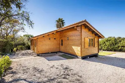 a small wooden building with a palm tree behind it at Vistas Algarve in Loulé