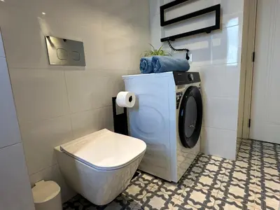 a washing machine in a bathroom with a toilet at BnB Homes Ocean Breeze Terrace Apartment 400 m away from the Ocean in Albufeira