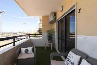 a balcony with chairs and a view of a city at Dunas - Sea view near the beach by HD in Quarteira