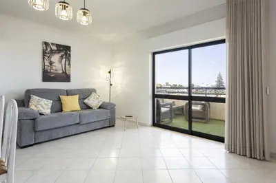 a living room with a couch and a large window at Dunas - Sea view near the beach by HD in Quarteira