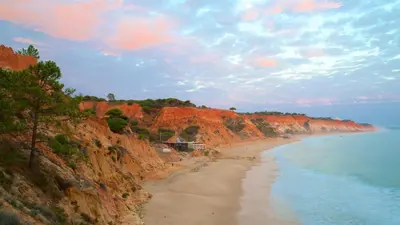 a view of a beach next to the ocean at Cozy Villa next to the Golf Course by Algarve Dream Holidays in Quarteira