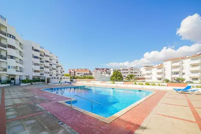 a large swimming pool in the middle of a building at Coral by MTPhomes in Albufeira