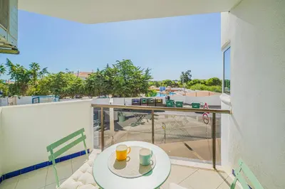 a balcony with a table and a view of a playground at Coral by MTPhomes in Albufeira