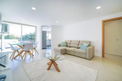 a living room with a couch and a table at Coral by MTPhomes in Albufeira