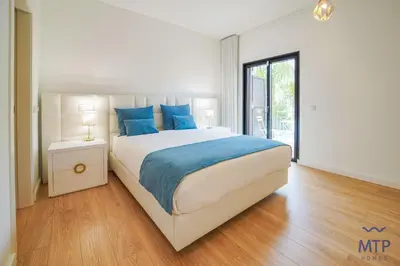 a white bedroom with a bed and a window at Vila Cascata by MTPhomes in Branqueira