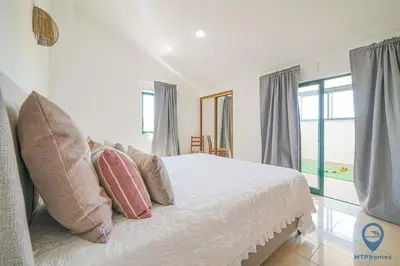 a bedroom with a white bed with pillows at Casa Joana by MTPhomes in Albufeira