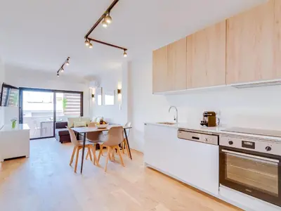 a kitchen and dining room with a table and chairs at AL - Apartamento Mira Atlantico in Quarteira
