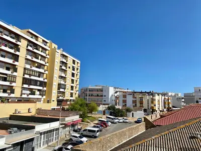 a city with cars parked in a parking lot at Blife Anya private apartment in Faro