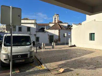 a small kitchen with a stove and a refrigerator at 3F Bocage - Centro de Faro in Faro