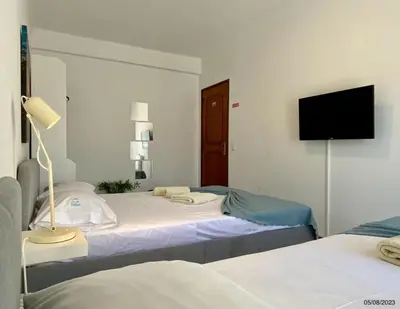 a bedroom with two beds and a flat screen tv at Blife Julya private apartment in Faro