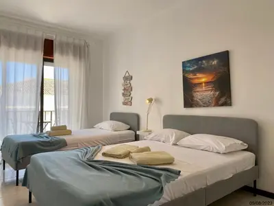 a bedroom with two beds and a window at Blife Julya private apartment in Faro