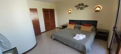 a resort with a swimming pool and chairs and buildings at Albufeira Apartment, Pool and Sea view in Albufeira