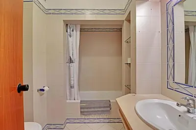 a resort with a swimming pool and lounge chairs at Albufeira Apartment, Pool and Sea view in Albufeira