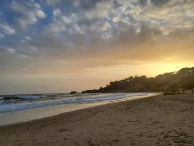 a view of the beach at sunset at Corcovada Dream Apartment in Albufeira