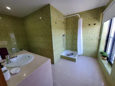 a bathroom with a tub and a sink and a shower at Corcovada Dream Apartment in Albufeira