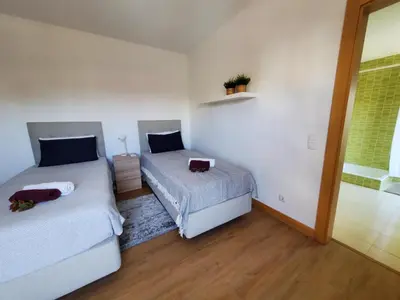 a bedroom with two beds and a window at Corcovada Dream Apartment in Albufeira