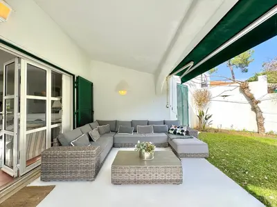 a living room with a couch and a table at Vilamoura Amazing Villa 2 With Pool by Homing in Vilamoura