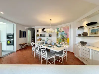 a kitchen and dining room with a white table and chairs at Vilamoura Amazing Villa 2 With Pool by Homing in Vilamoura