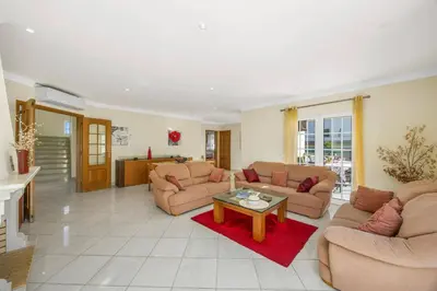 a living room with two couches and a coffee table at Villa Caly by Villa Plus in Roja- Pé