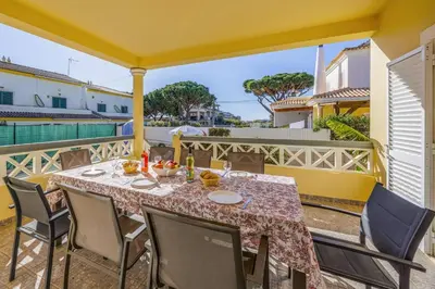 a dining table on a balcony with a view of the water at Villa Caly by Villa Plus in Roja- Pé