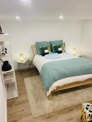a bedroom with a large bed with green pillows at Confort à Loulé in Loulé