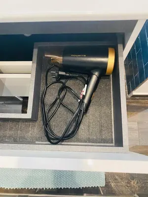 a blow dryer in a drawer in a cabinet at Confort à Loulé in Loulé